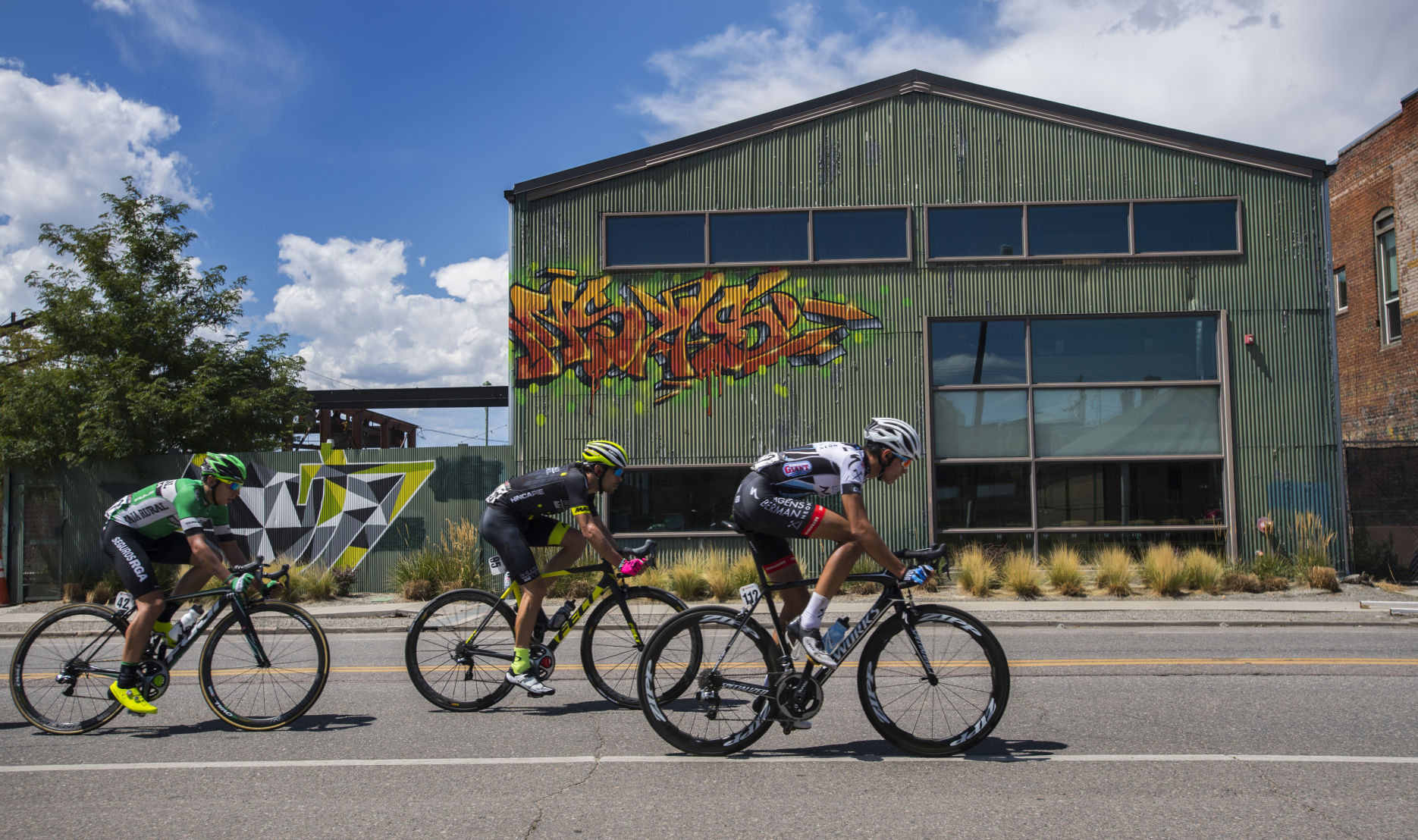 Christopher Blevins, front, Ruben Companioni, and Antonio Molina Canet race down Larimer Street during Stage 4, the final stage, of the Colorado Classic in Denver Sunday, Aug. 13, 2017. (The Gazette, Christian Murdock)